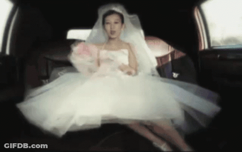Bride In White Dress Sitting In Back Of Car GIF