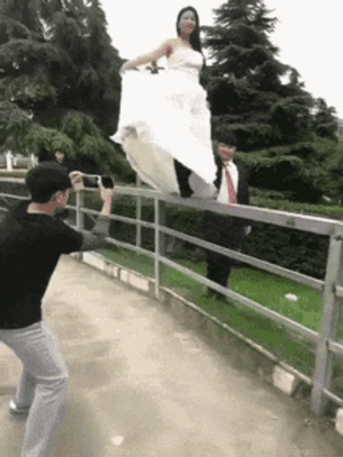 Bride Sliding Down The Fence Funny Wedding GIF