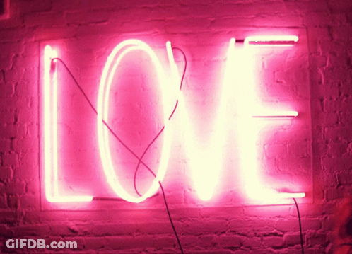Bright Pink Neon Sign Saying Love On Brick Wall GIF