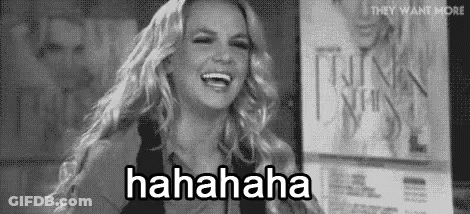 Britney Spears Is Laughing In A Black And White Photo While Standing In Front Of A Sign . GIF