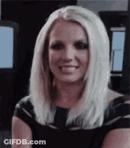 Britney Spears Is Smiling And Wearing A Black Dress . GIF
