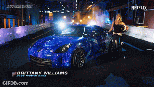 Brittany Williams Standing Next To Blue Nissan 380Z GIF