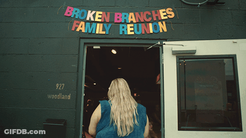 Broken Branches Family Reunion Is Advertised On A Black Building GIF