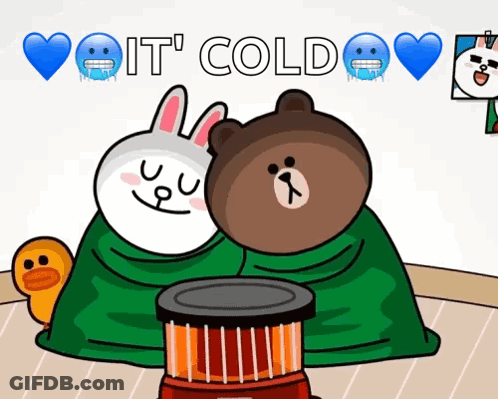 Brown Bear And White Rabbit Wrapped In Green Blanket Next To Heater GIF