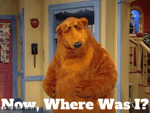 Brown Bear In Hallway Saying Now Where Was I GIF