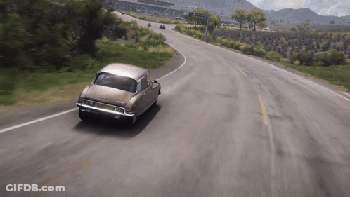 Brown Car Driving Past Avenida Sign GIF