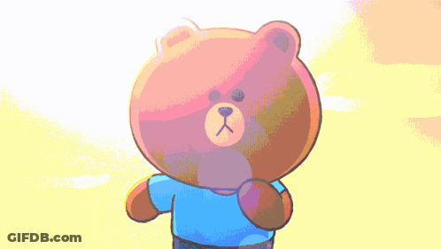 Brown Teddy Bear In Blue Shirt In Front Of Yellow Background GIF