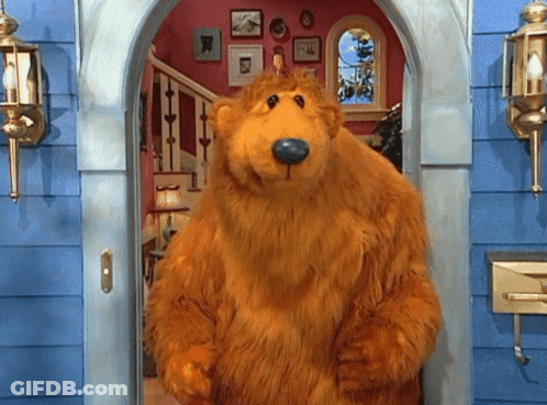 Brown Teddy Bear With Blue Nose Standing In Doorway GIF