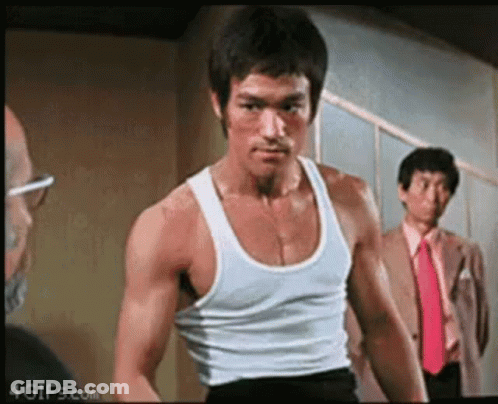 Bruce Lee In White Tank Top And Black Shorts GIF