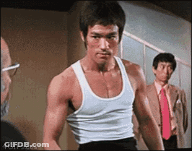 Bruce Lee In White Tank Top And Red Tie In Front Of Two Men GIF