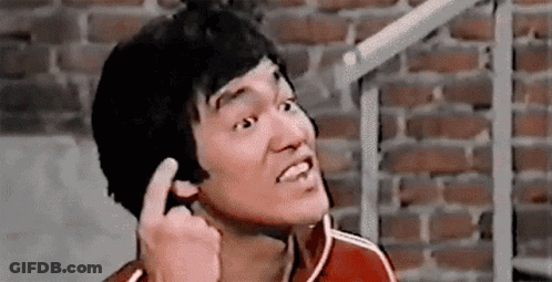 Bruce Lee Making Funny Face And Giving Middle Finger GIF
