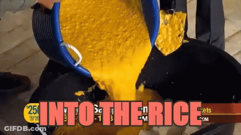 Bucket Of Yellow Liquid Poured Into Black Pan Into The Rice GIF