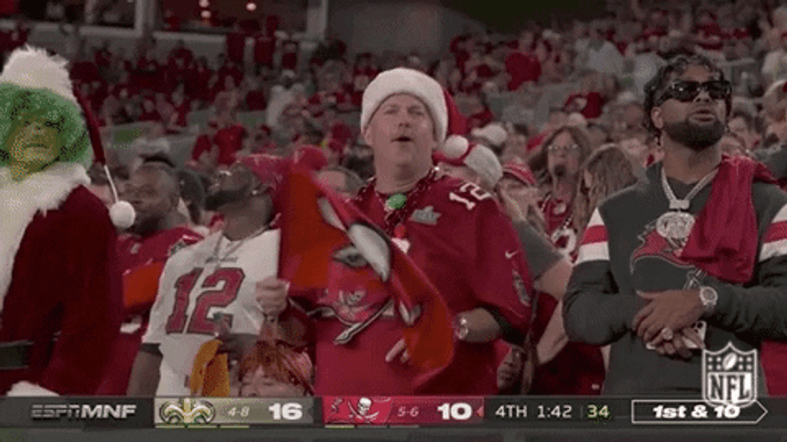Bucs Fan Wearing Santa Hat Waving Banner GIF