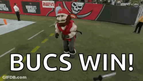 Bucs Mascot Standing On Field Saying Bucs Win GIF