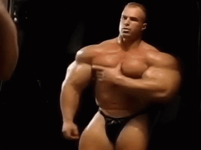 Buffed Guy Holding Chest Muscle Growth GIF