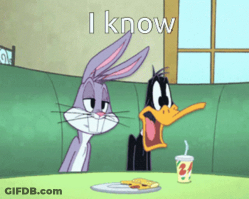 Bugs Bunny And Daffy Duck Sit At A Table With A Plate Of Food GIF