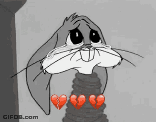 Bugs Bunny From Looney Tunes Is Crying With Broken Hearts Around Him . GIF