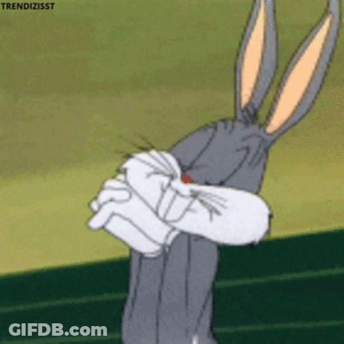Bugs Bunny From Looney Tunes Is Holding His Fist Up In Front Of His Face GIF