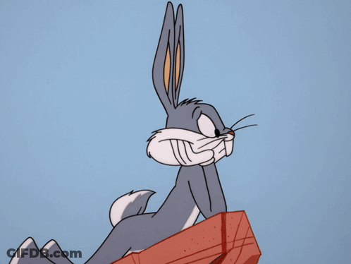 Bugs Bunny From The Looney Tunes Show Is Sitting On A Red Box GIF