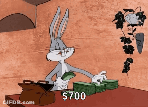 Bugs Bunny Is Sitting At A Table With A Stack Of Money . GIF