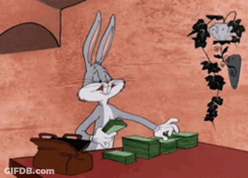 Bugs Bunny Is Sitting At A Table With Stacks Of Money And A Briefcase GIF
