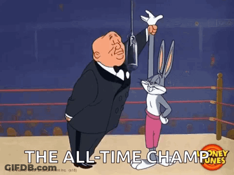 Bugs Bunny Is Standing Next To A Man In A Tuxedo In A Boxing Ring Holding A Trophy . GIF