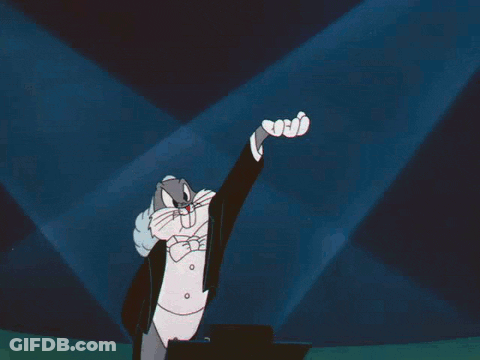 Bugs Bunny Is Wearing A Tuxedo And Bow Tie And Raising His Hand GIF