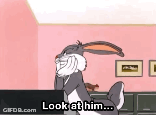 Bugs Bunny On Pink Wall With Look At Him Sign GIF