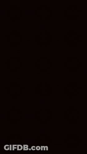 Building Lit Up At Night With Balcony GIF