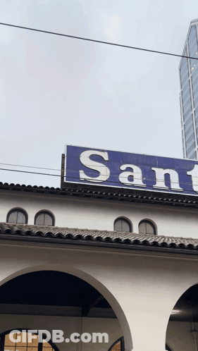 Building With Blue Sign Saying Sant GIF