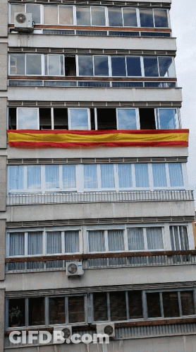 Building With Red And Yellow Flag GIF