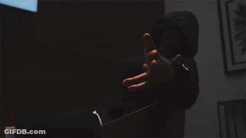 Bullet Holes In A Broken Glass Window With A Person Behind It GIF