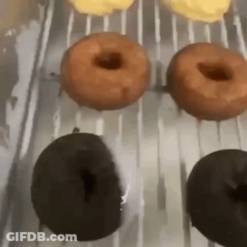 Bunch Of Donuts On Cooling Rack GIF