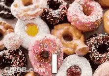 Bunch Of Donuts With Sprinkles Stacked GIF