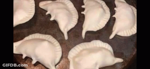 Bunch Of Dumplings Stacked On Pan GIF