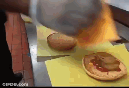 Bunch Of Hamburgers On Yellow Cutting Board GIF