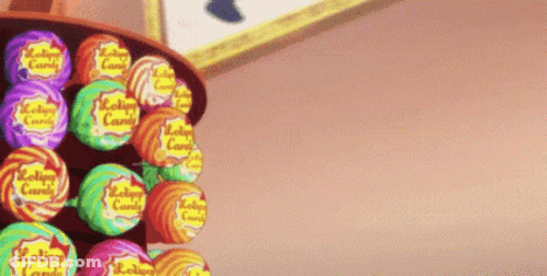 Bunch Of Lollipops Lined Up On Shelf GIF