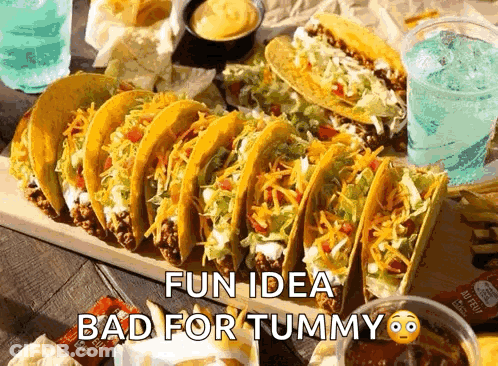 Bunch Of Tacos On Wooden Cutting Board GIF
