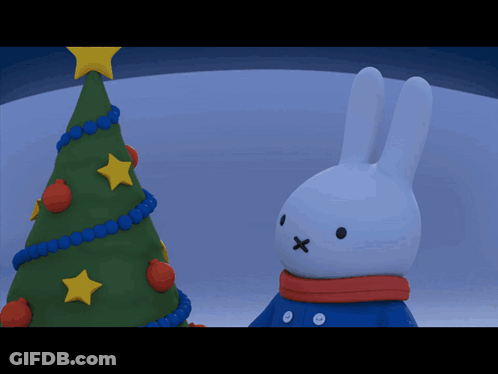 Bunny With Scarf In Front Of Christmas Tree GIF