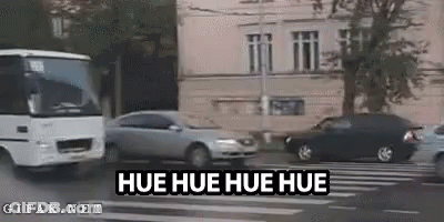 Bus Driving Beside Car And Building GIF
