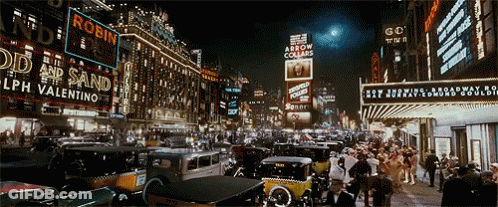 Busy Night Street With Robin Sign GIF
