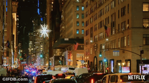 Busy Street With Netflix Sign On Van GIF