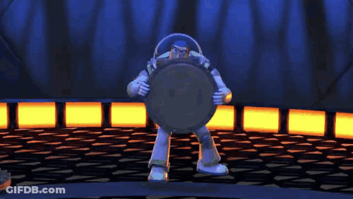 Buzz Lightyear From Toy Story Is Standing In A Dark Room Holding A Shield GIF