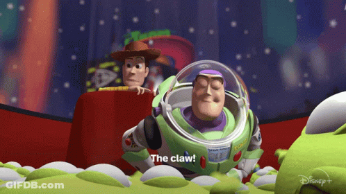 Buzz Lightyear From Toy Story Says The Claw While Woody Watches GIF