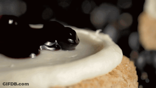 Cake With White Frosting And Blueberry Sauce GIF