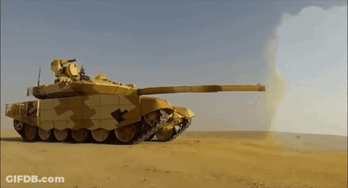 Camouflaged Tank Firing Rocket In Desert GIF