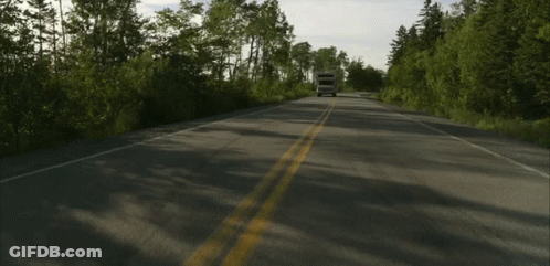 Camper Driving On Road With Trees GIF