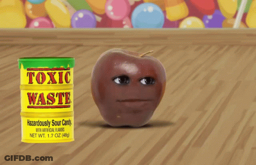Can Of Toxic Waste Next To Apple On Wooden Table GIF