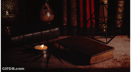 Candle Next To Book Saying A GIF