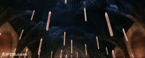 Candles Hanging From The Ceiling In A Dark Room GIF